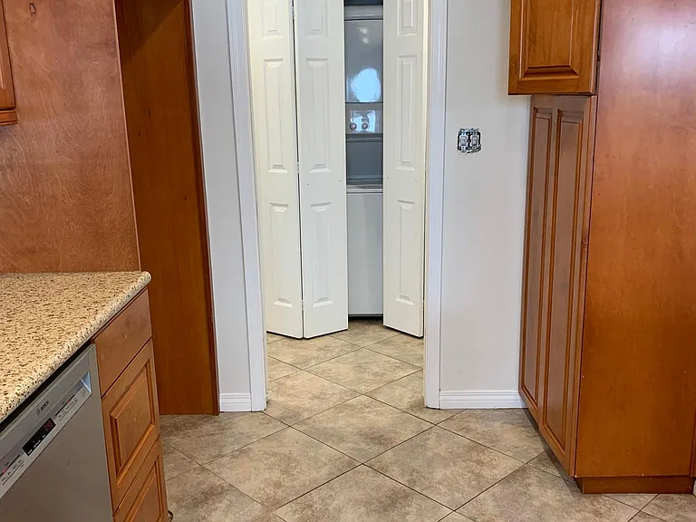 from kitchen toward laundry room washer dryer & hall