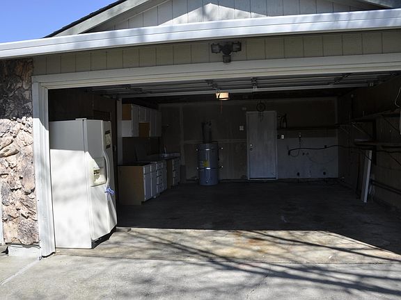 Garage with cabinets and laundry hook-ups
