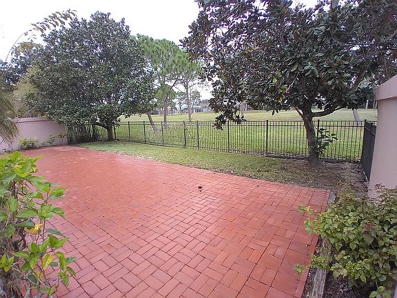 Brick backyard with gate to golf