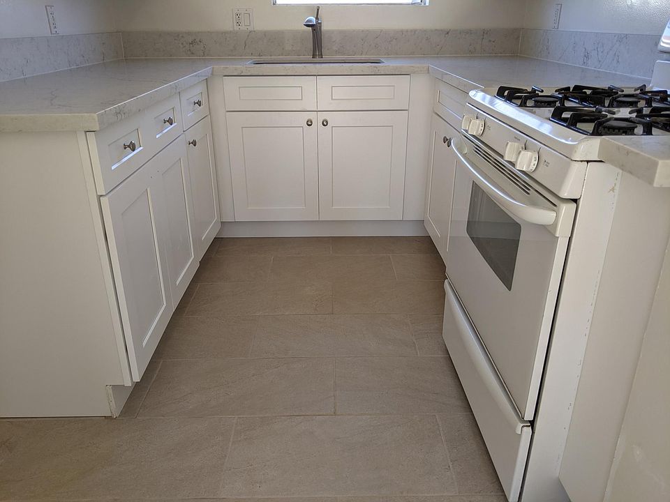 kitchen with new flooring, new base cabinets, and new quartzite countertops