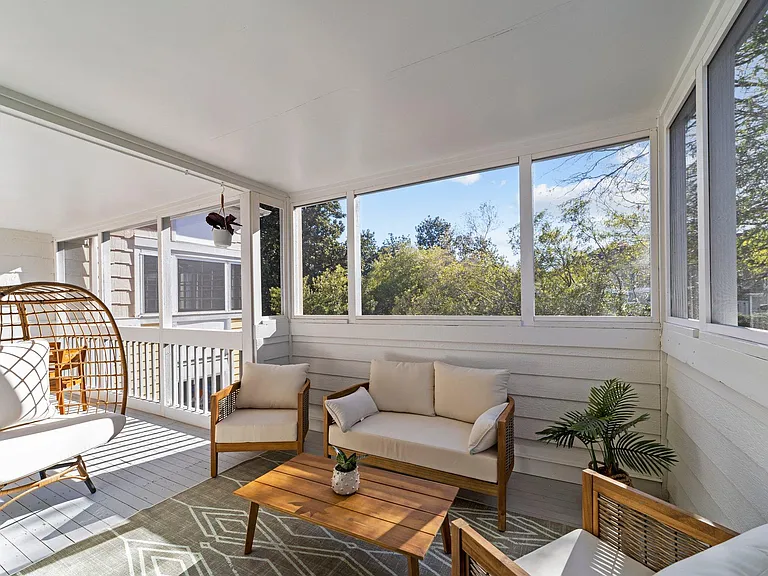 Screened in porch area off of the living room. Runs the entire width of the condo!