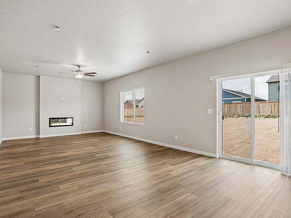 The family room is spacious with a ceiling fan.