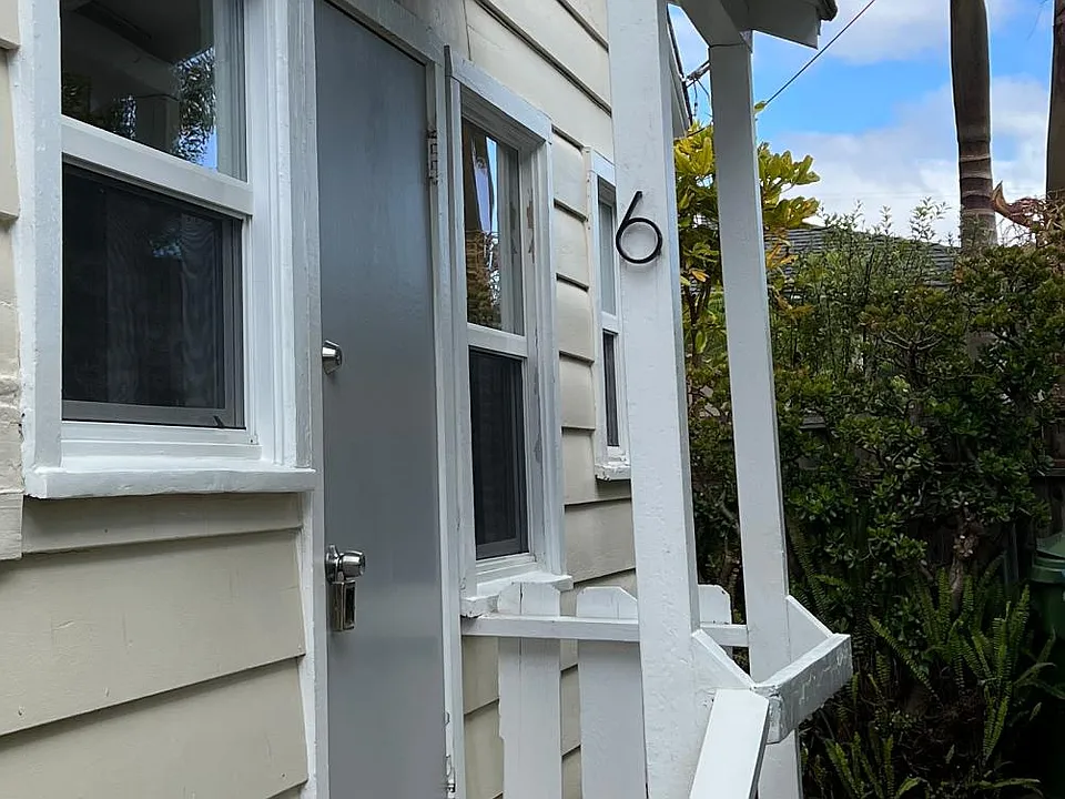 One of two entry doors. This one enters kitchen area as a walk through to living room.