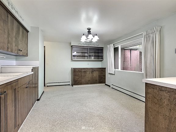View of kitchen into dining room, second sink, more countertops and cabinets to your left. 