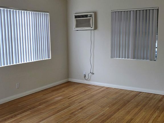 Living room with AC unit and new window covering