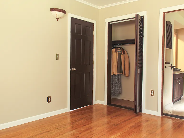 Large sunny Master bedroom leading to bath and hallway
