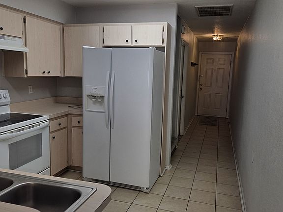 Kitchen towards front door and garage entrance