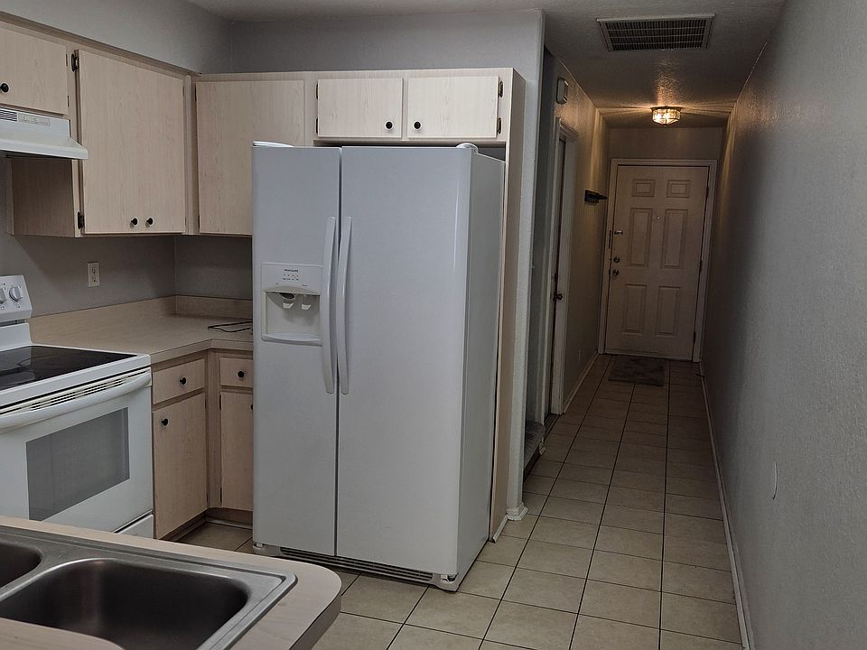 Kitchen towards front door and garage entrance