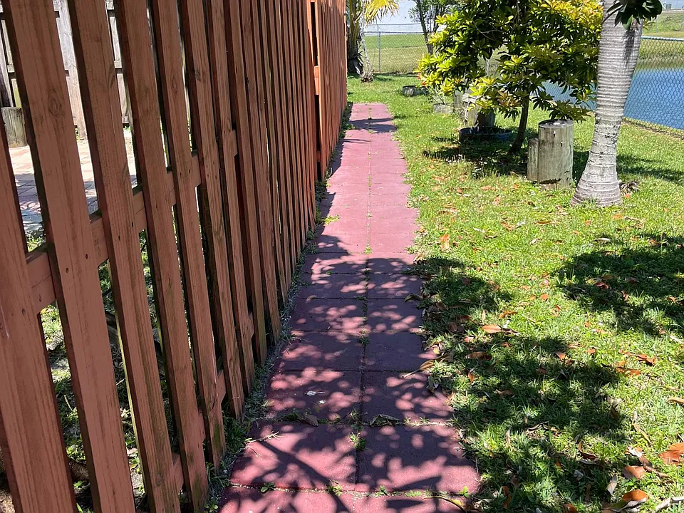 Walkway to entrance next to fenced pond