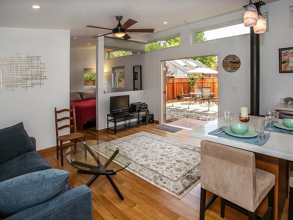 View of backyard patio. Queen sofa bed in living-room. Ceiling fan.