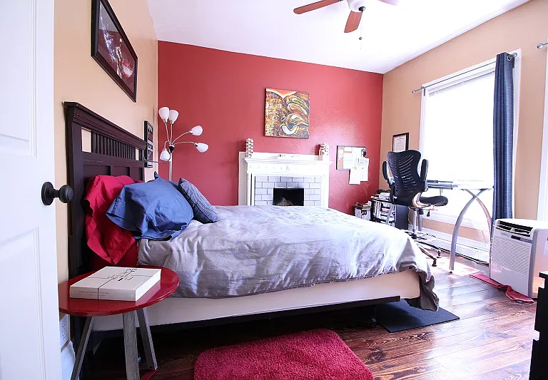 Bedroom 1 with large windows and views of Washington Street and downtown.