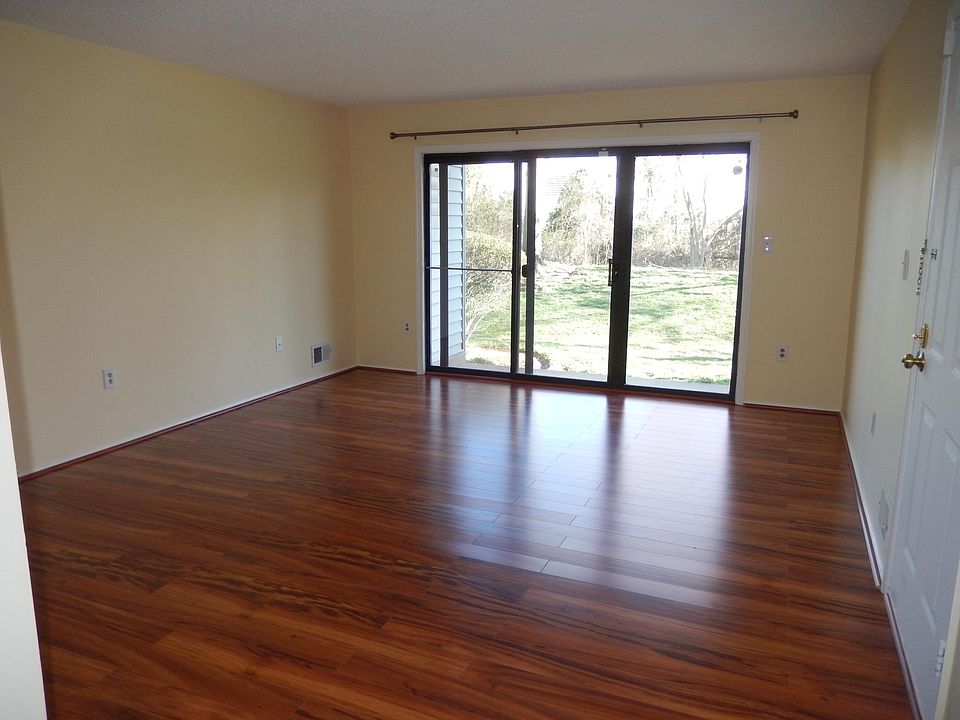 Living room with patio facing woods.