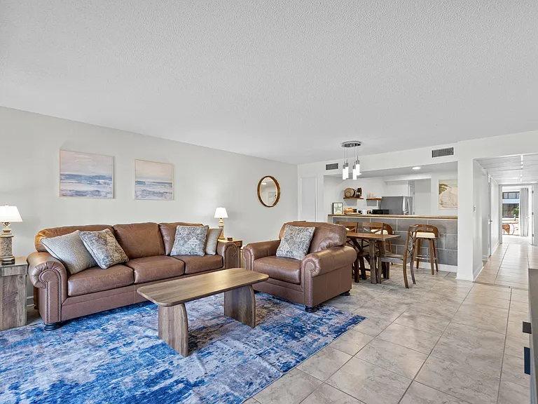 The sofa is a queen sleeper sofa. The white chest in the living room contains linens for this extra bed.
