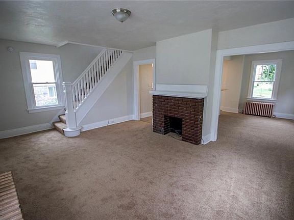 Living Room With Decorative Fireplace Open to Dining Room