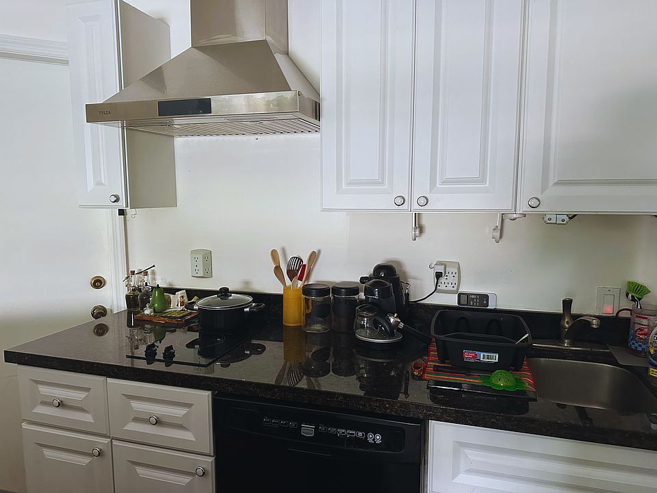 Kitchen with exhaust extractor vented directly outside and dishwasher