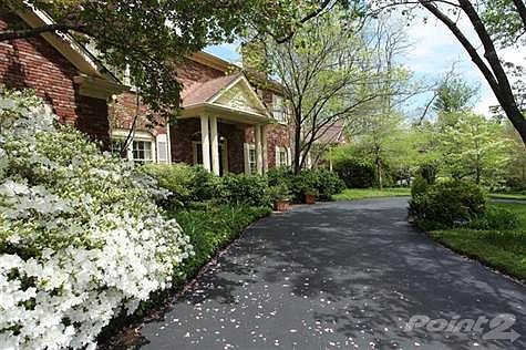 Stately 2 story with semi-circular driveway.