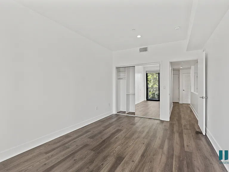 Bedroom with Mirrored Closet, Recessed Lighting, and Vinyl Flooring