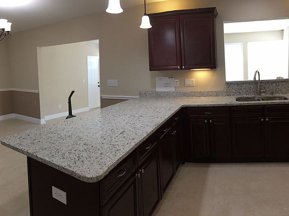 granite countertop eating area dinette and entry to Florida room