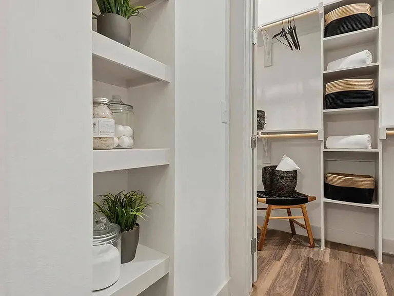 Walk-In Closet with Open Shelves, Hanging Rods, and Storage Baskets