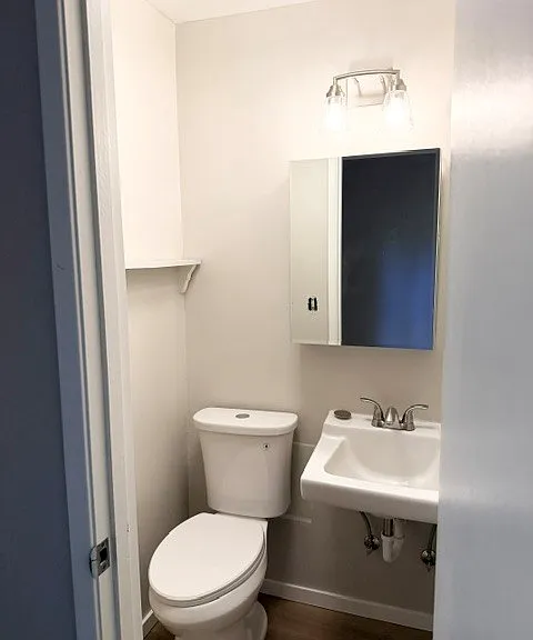 Half bath located off the kitchen.
