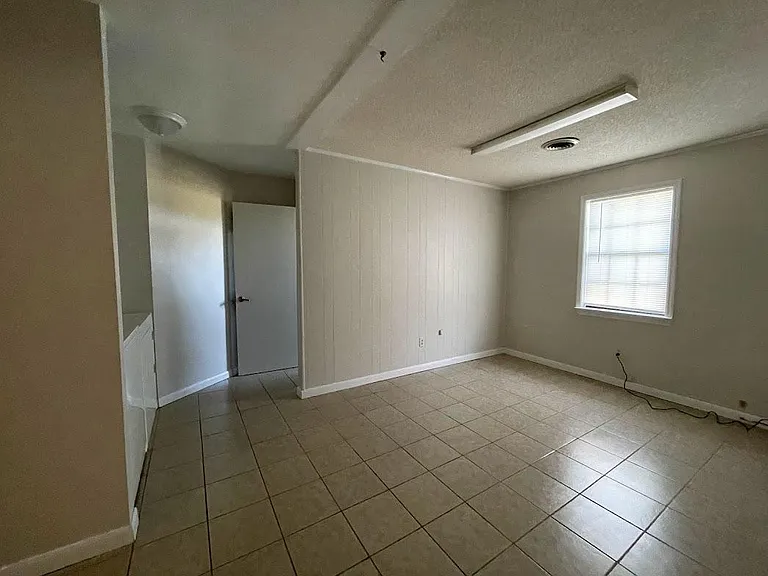 Living Room Area Leading to Bathroom and Laundry area