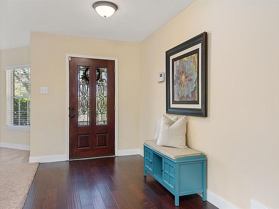 The entry way is open to the formal living and dining area.