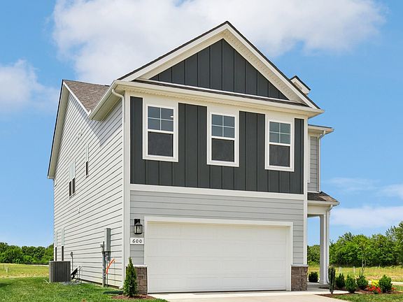 Home exterior with two tone blue siding and 2-car garage