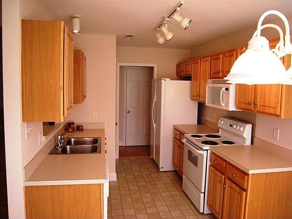 Kitchen has lots of counter space and track lighting