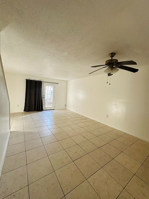 Living area, shows back double doors with blackout curtain.