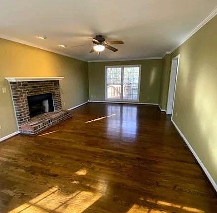 Spacious living room with gas fireplace and logs