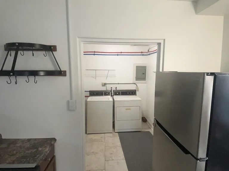 Kitchen connected to 1st floor laundry (top loading washer and dryer included in lease; Tenant responsible for maintenance & repairs).