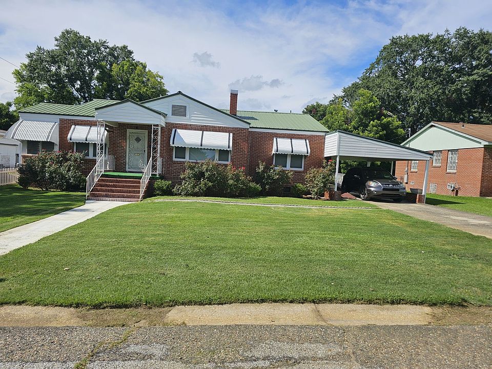 Front yard, carport to the right with long driveway, side door entrance into Room B via steps and disability ramp if needed
