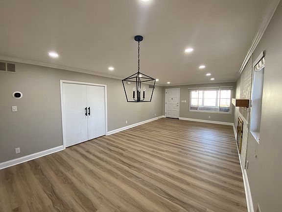 living and dining area with double pocket doors leading to bedrooms/bathrooms and view of front sunroom