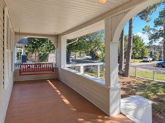 The spacious covered front porch has a classic porch swing that carries the traditional feel of southern porch living. It has beautiful curved architectural arches that frame the porch and reflect the character of this 1940's Eastwood home.