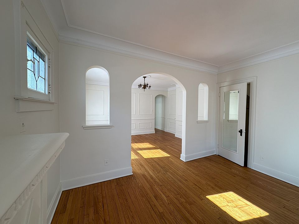 View of living room to dining room. Coat closet with full length mirror.