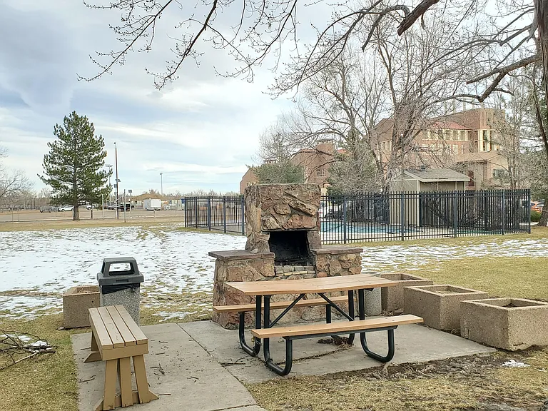 Park like space with fireplace, grills, and picnic tables