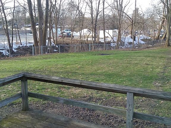 Large fenced in yard with deck