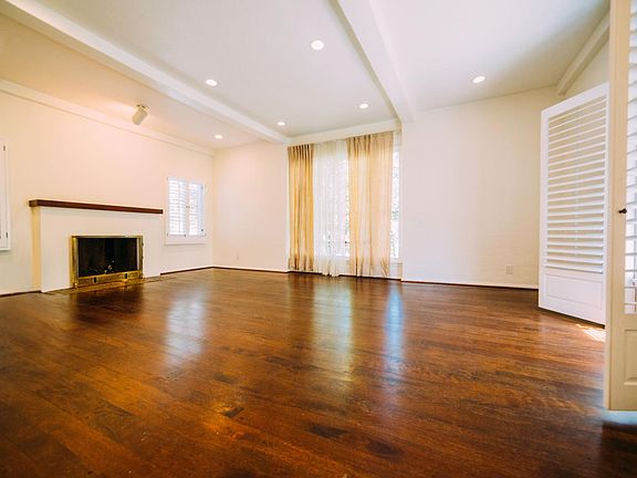 Beautiful living room- hardwood floors, beamed ceiling, recessed lighting-