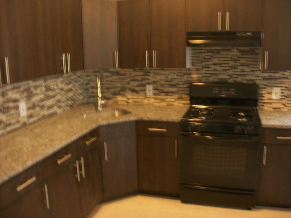 Beautiful renovated kitchen, tiled backsplash, granite count