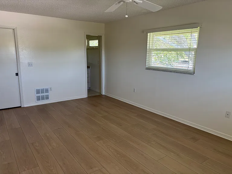 Master bedroom shaded by beautiful oak tree.