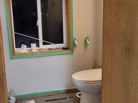 Bathroom with new shower and newer laminate flooring.