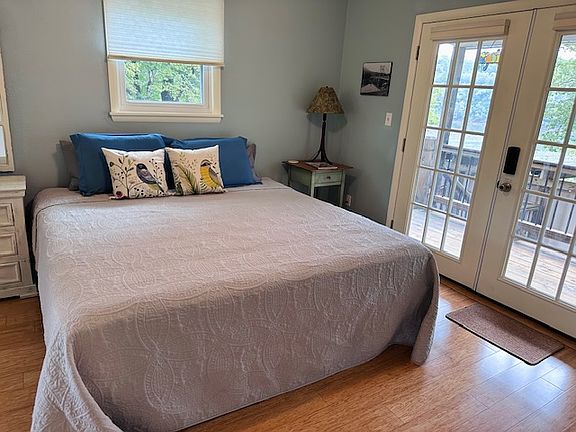 King bed and full bath on this side, plus closet, bureau, and smart TV.