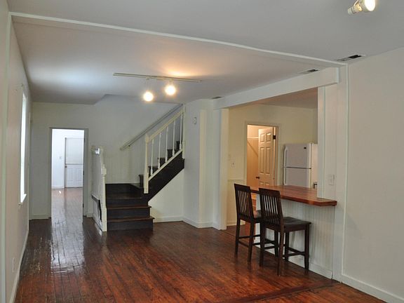 living/dinning room showing downstairs bedroom beyond
