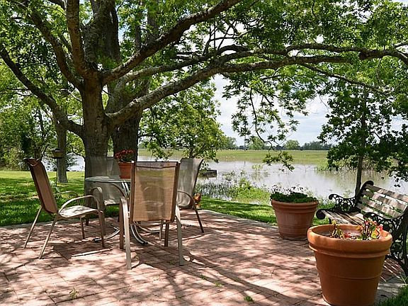 3.  Step out the Family Room door and you are greeted by a wonderful bricked Patio that overlooks Bessie's Creek.   It extends the living area to the outdoors while offering  incredible ambiance and stunning views