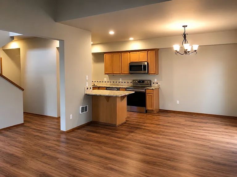 View from livingroom onto open kitchen area and stairway.