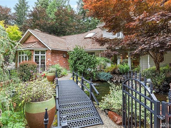 Custom bridge over koi pond welcomes you to the front door.  