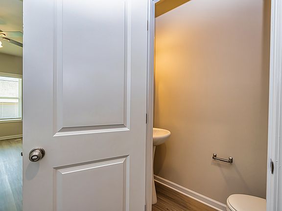 Convenient half bath: A stylish powder room just off the main living area, perfect for guests or quick access during the day.