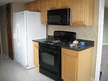 Refrigerator, gas cook range and Microwave ( with exhaust vented out). Entire floor : Entrance,formal dining, half bath, hallway and breakfast area is tiled.
