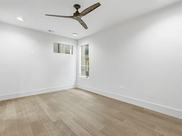 Comfortable bedroom with ceiling fan and neutral finishes