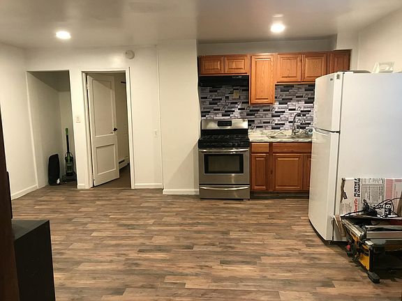 Standing in living room facing kitchen. On left is laundry hookup and bedroom #1.